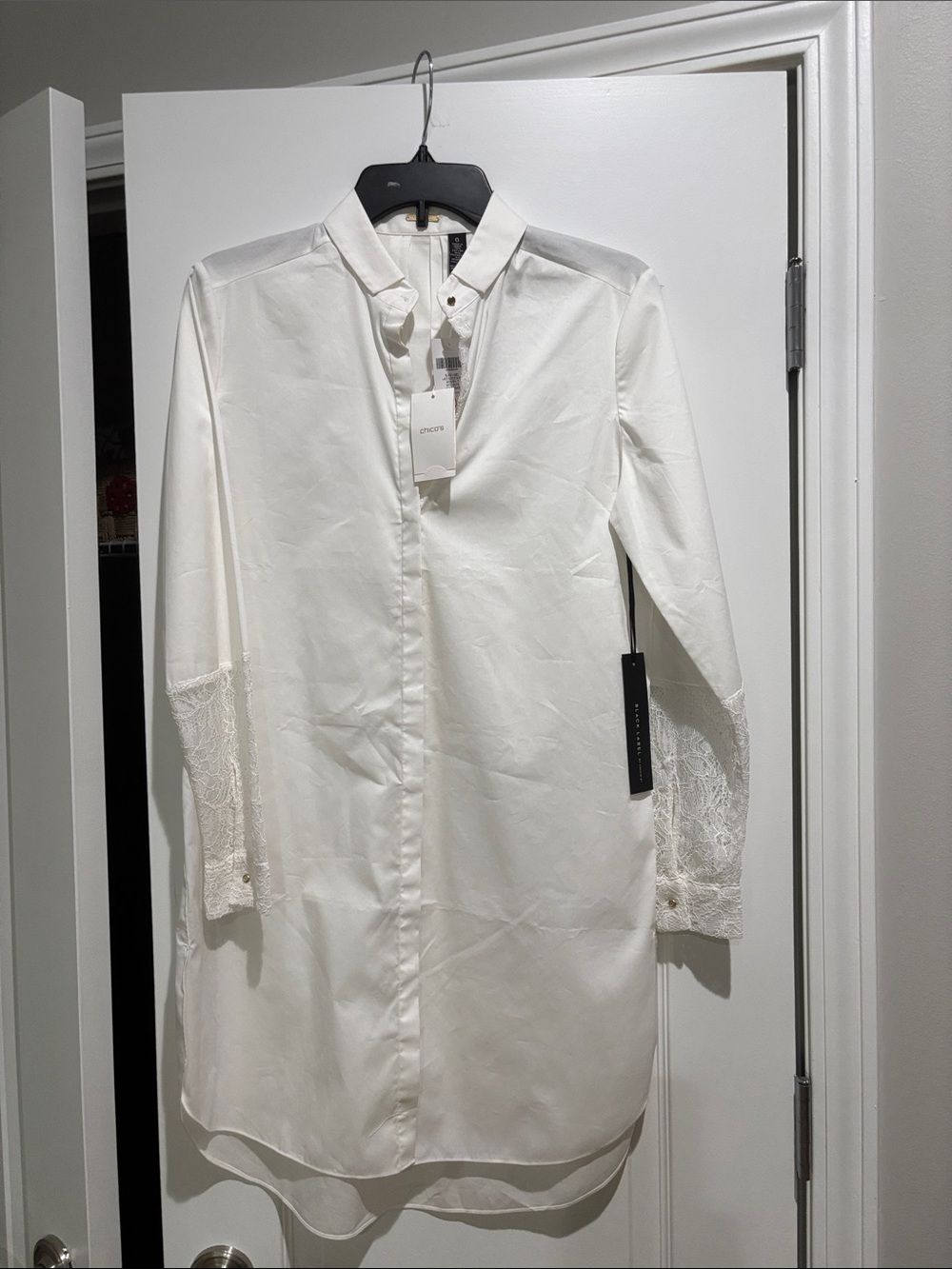 Chico's, White blouse, size 0 with lace cuffs on the sleeves.